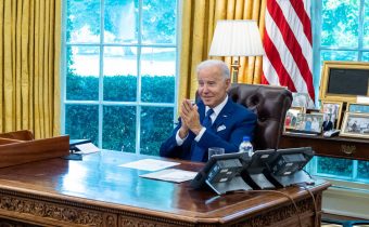 President Joe Biden talks with staff before a virtual call with Pell Grant recipients Monday, August 29, 2022, in the Oval Office. (Official White House Photo by Adam Schultz)