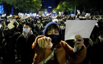 People hold white sheets of paper in protest over coronavirus disease (COVID-19) restrictions, after a vigil for the victims of a fire in Urumqi, as outbreaks of COVID-19 continue, in Beijing, China, November 27, 2022. REUTERS/Thomas Peter